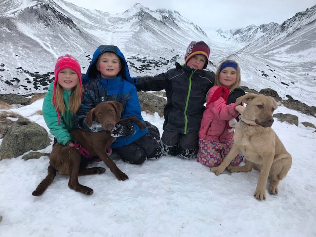 Kids and puppies in the snow